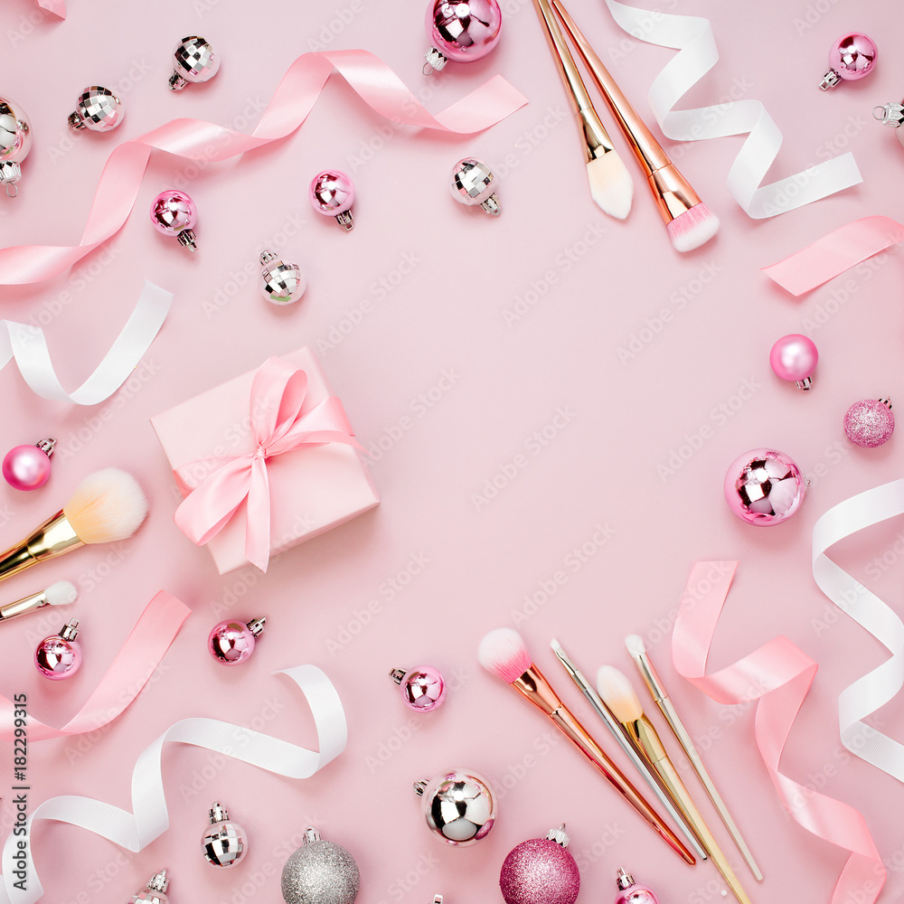 Frame with Christmas ball, gift, ribbon, cosmetic and decorations in pastel  pink colour. Holiday Background. Beauty concept. Flat lay, top view Stock  Photo | Adobe Stock
