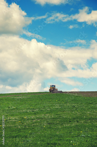 Agriculture tractor cultivating field.Springtime.Arable land.Ploughing.