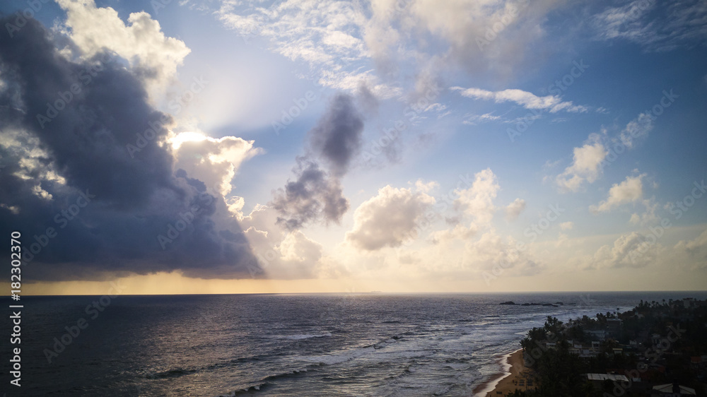 Clouds over ocean coast line in jungle aerial shot