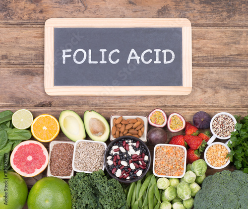 Folic acid food sources, top view on wooden background 