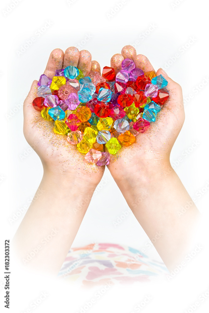 children's hands, hands holding beads on a white background
