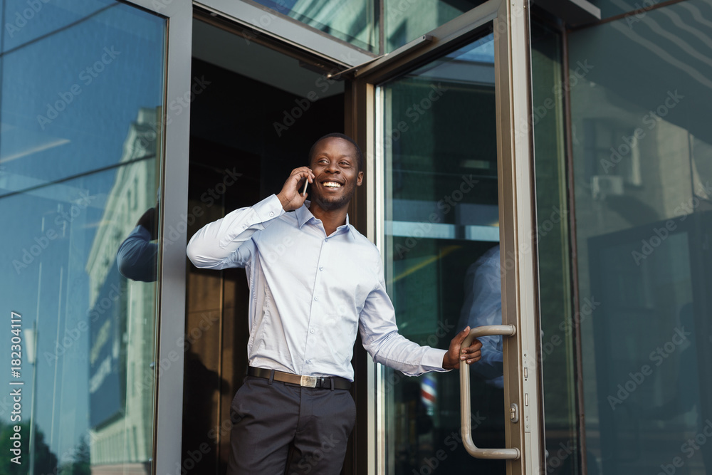 Portrait of a confident young black businessman talking on cell phone Portrait of a confident young black businessman talking on cell phone
