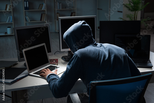 Hacker hacking computer at night