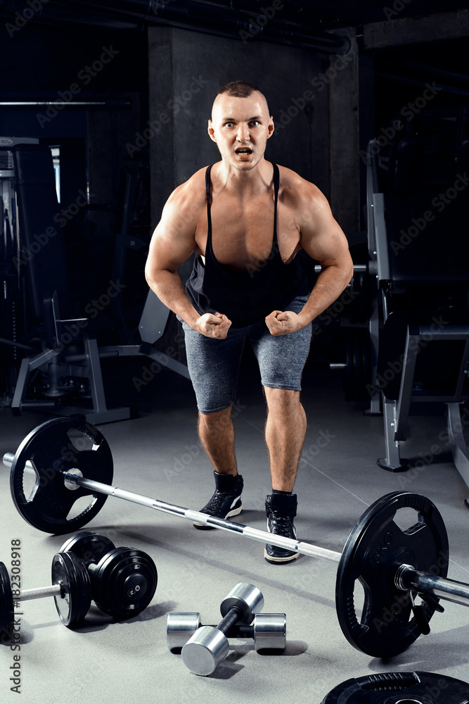 Strong bodybuilder man with perfect abs, shoulders, biceps, triceps.
