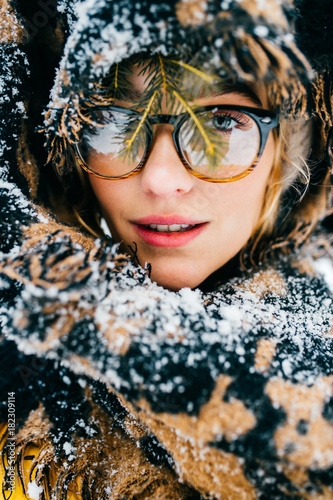 Odd unordinary bizarre kinky unique person. Clseup portrait of beautiful woman model in winter snowy forest with abstract background. Cute young girl with angelic face. Mystery eyes look. Frost day. photo