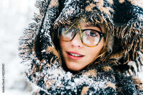 Odd unordinary bizarre kinky unique person. Clseup portrait of beautiful woman model in winter snowy forest with abstract background. Cute young girl with angelic face. Mystery eyes look. Frost day. photo