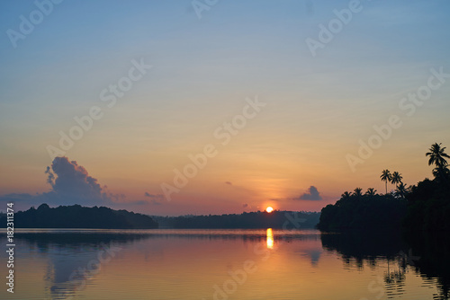 beautiful sunrise over tropical lake © Alexander Belinskiy