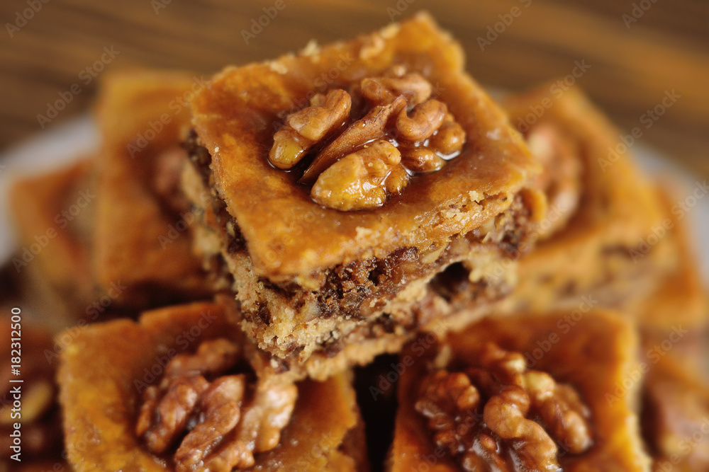 appetizing baklava with nuts and honey closeup on a wooden background appetizing baklava with nuts and honey closeup on a wooden background