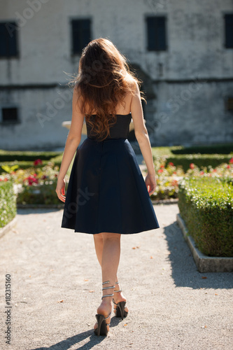 Beautiful young woman model in blue dress posing outdoor in the park © Samo Trebizan