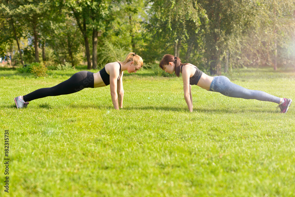 Fototapeta premium girls in the park to warm up