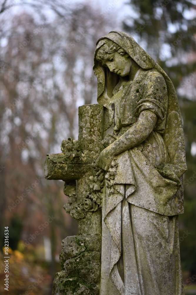 Old statue on a closed graveyard