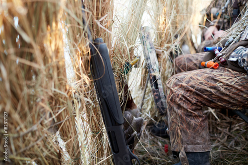 Hunters waiting inside a blind or hind on a shoot