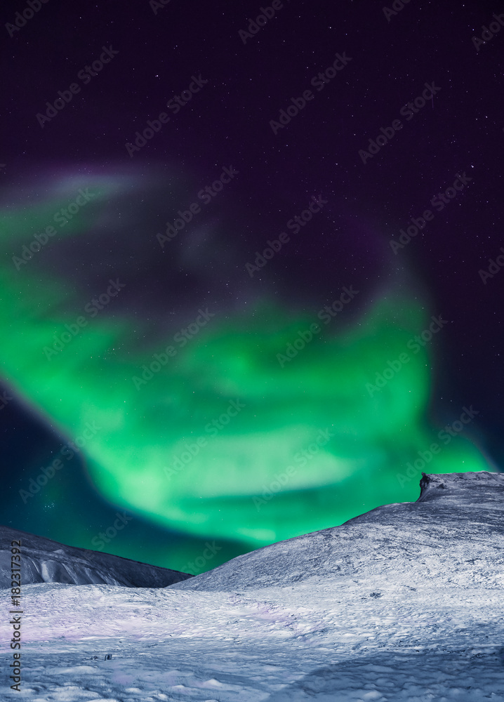 The polar arctic Northern lights aurora borealis sky star in Norway Svalbard in Longyearbyen city the moon mountains