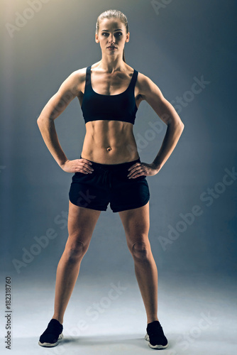 Strong body and mental health. Full length shot of a female athlete in a two piece sportswear standing on the feet more than shoulder width apart and looking into the camera confidently.