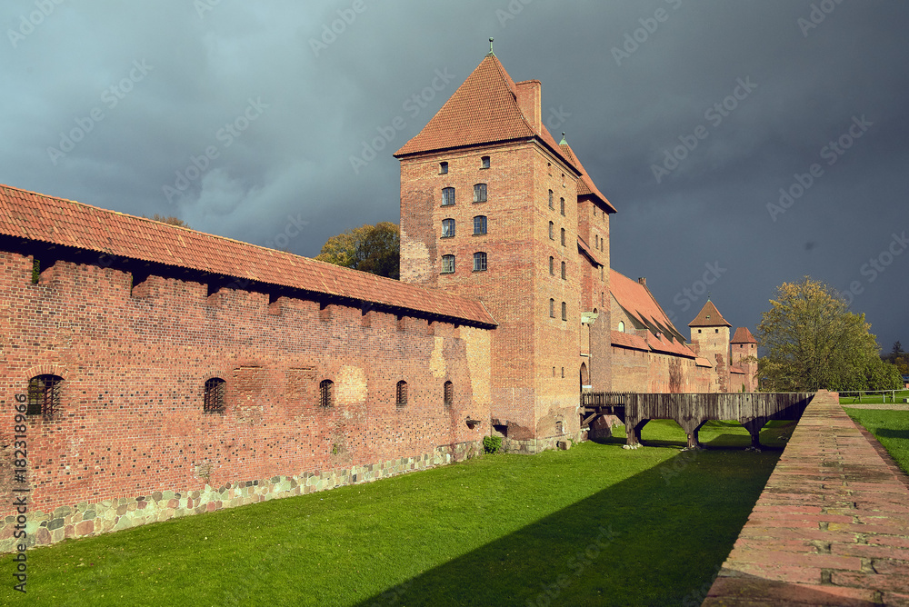 Fortress walls in Castle of the Teutonic Order in Malbork, Poland. Red brick wall and Tower.