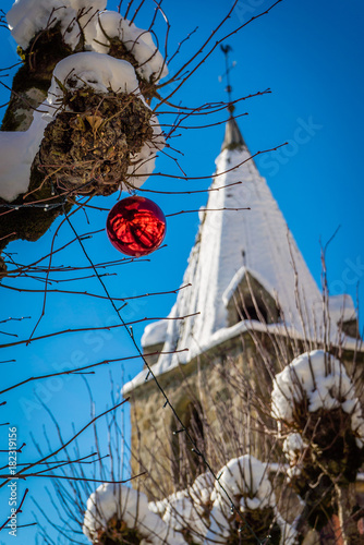 Christmas ball and clock tower in the snow photo