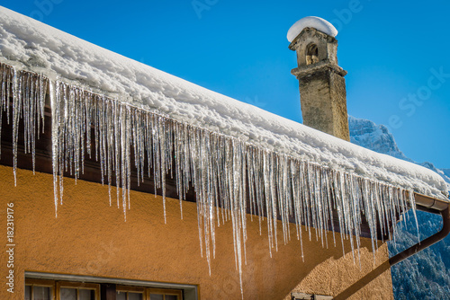 Ice stalactites on a roof photo