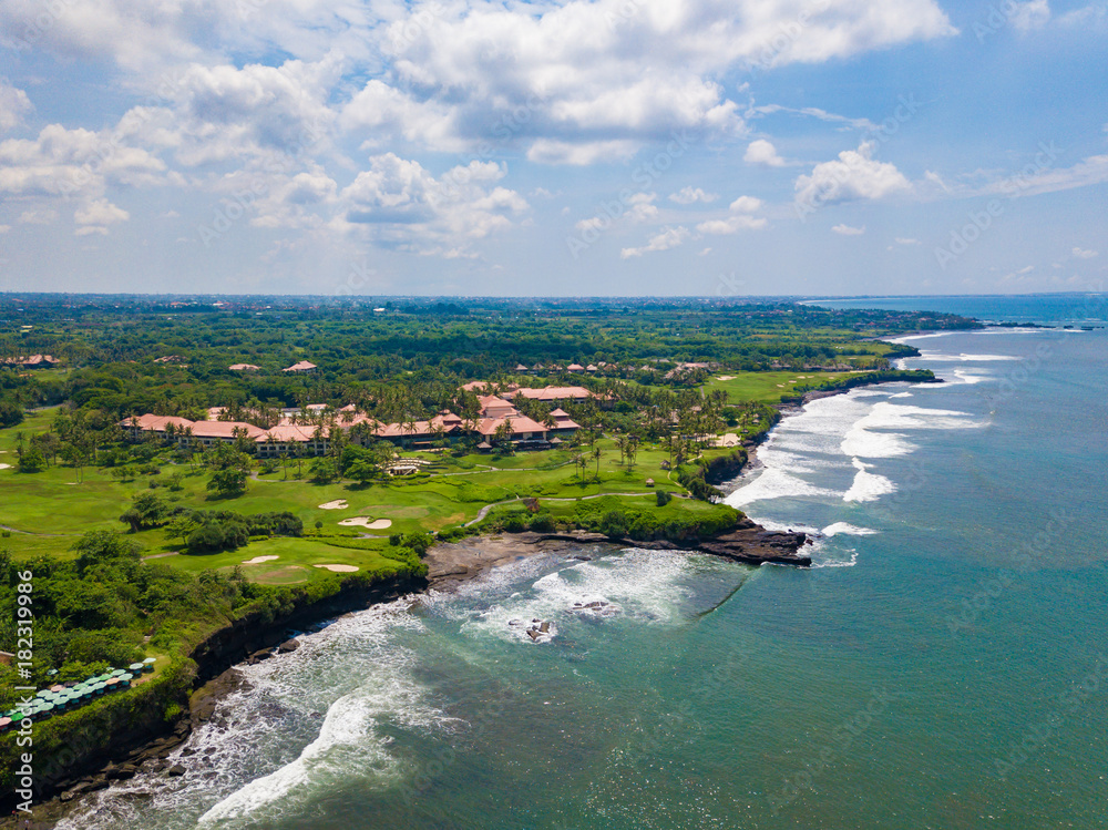 Obraz premium Beautiful aerial view of the sea landscape and golf field near Tanah lot temple, Bali island, Indonesia.