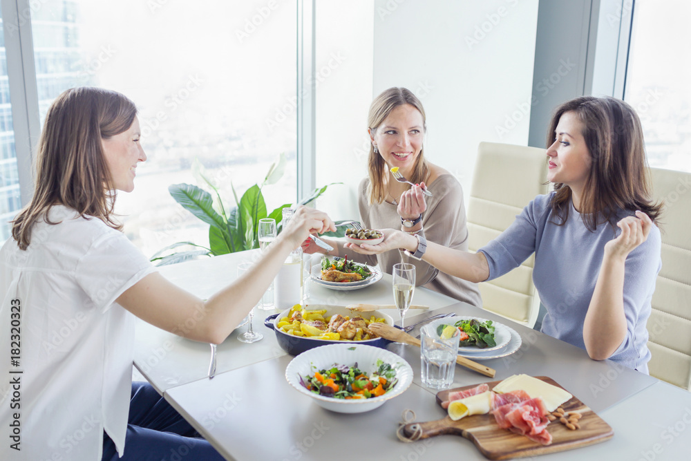 Young women having a dinner together Young women having a dinner together