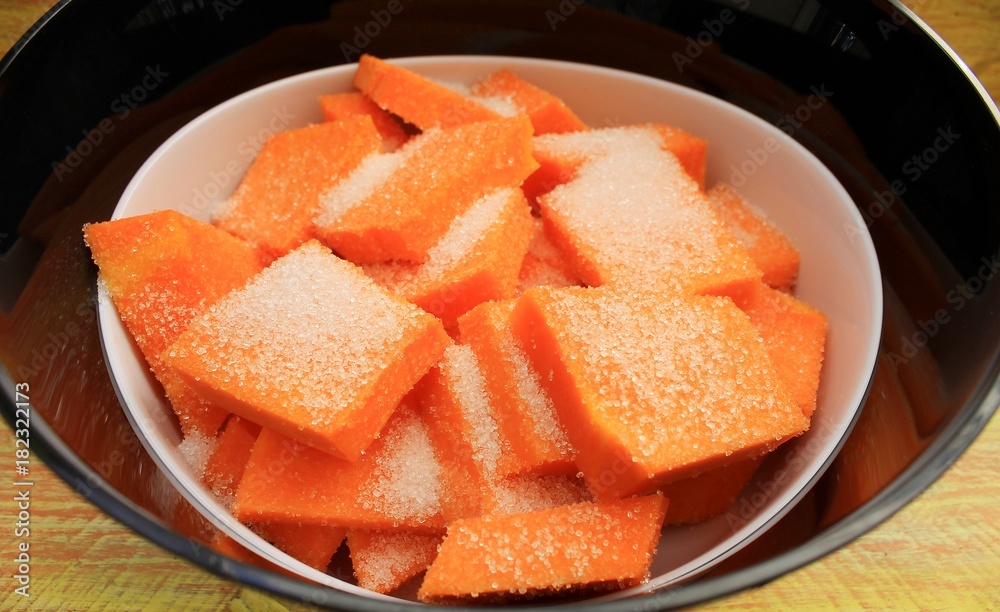 Pumpkin dessert in sugar syrup with walnuts