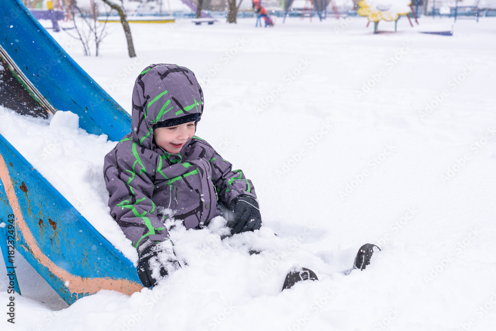 Little boy having fun in the snow