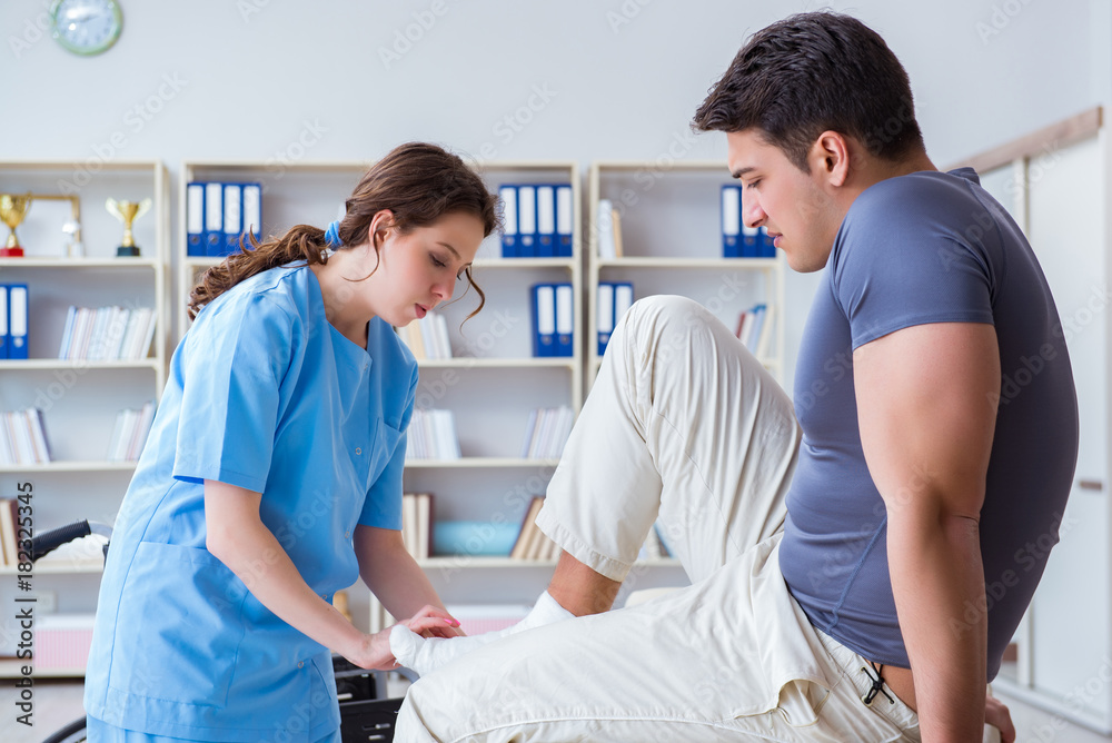 Fototapeta premium Doctor and patient during check-up for injury in hospital