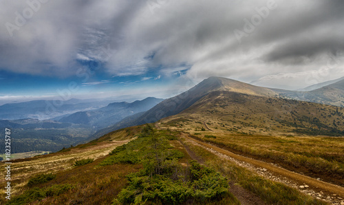 Trail in the mountains under cloudy sky. Carpathians
