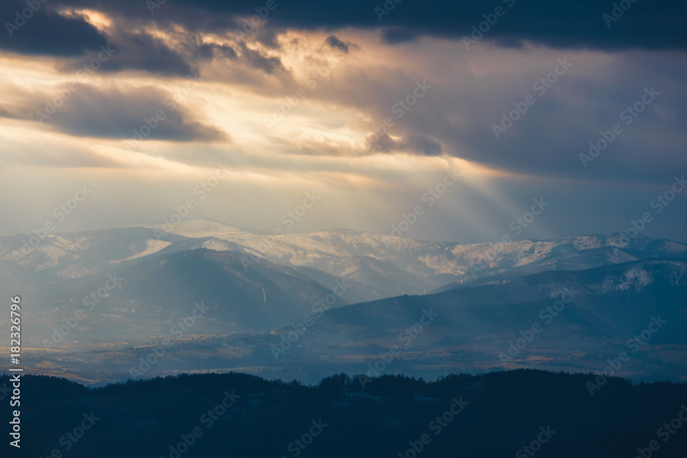 Rays of light pass through the clouds, mountain landscape