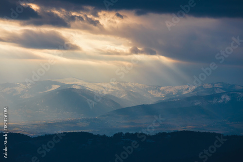 Rays of light pass through the clouds, mountain landscape