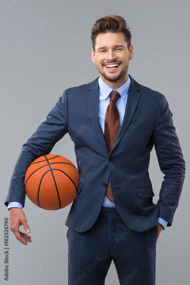 Happy elegant man with basketball. Business concept