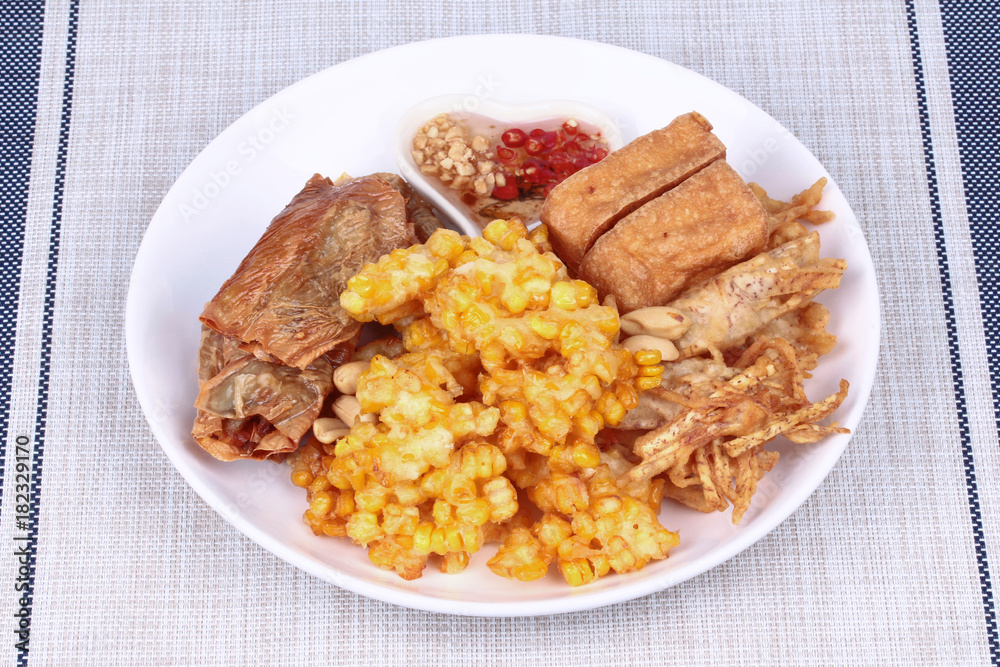Deep fried dessert of sweet corn,tofu ,taro and  spring roll served with spicy sweet sauce.