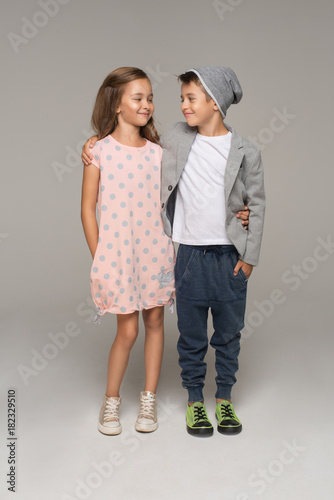 A portrait of a laughing girl and a smiling boy. summer style