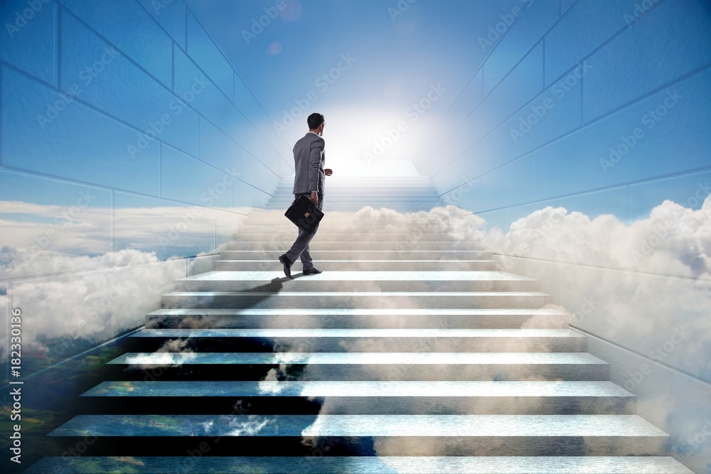 Businessman climbing up challenging career ladder in business co Businessman climbing up challenging career ladder in business co