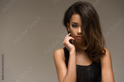 Natural young afro woman in black clothes