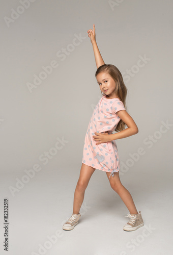 Happy young girl in pink dress