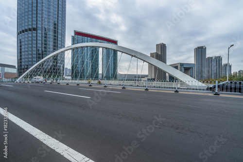 Fototapeta Naklejka Na Ścianę i Meble -  clean road and modern bridge with tianjin city skyline scenery,China.