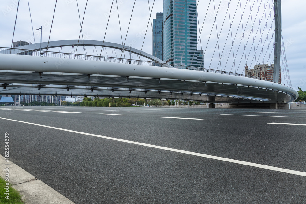 Empty urban road througe the bridge and modern skyline in Tianjin