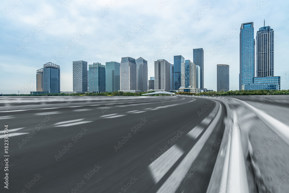 city empty traffic road with cityscape in background. city empty traffic road with cityscape in background.