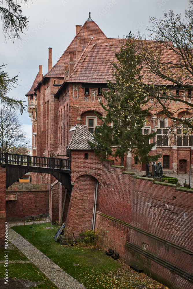 Fortress walls in Castle of the Teutonic Order in Malbork, Poland. Red brick wall and Tower. Fortress walls in Castle of the Teutonic Order in Malbork, Poland. Red brick wall and Tower.