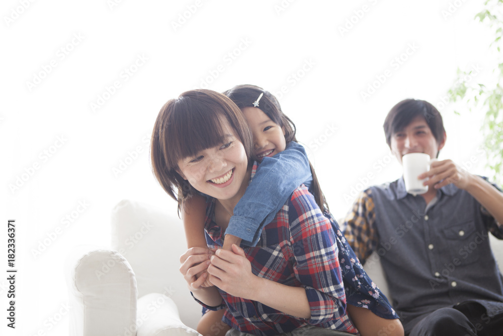 Parents and daughter are sitting on the sofa and talking. Parents and daughter are sitting on the sofa and talking.