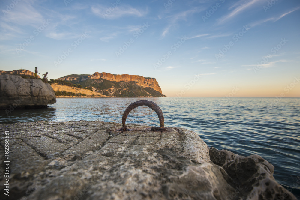 Fototapeta premium View of coastline in France with ancient ring for mooring boats in foreground