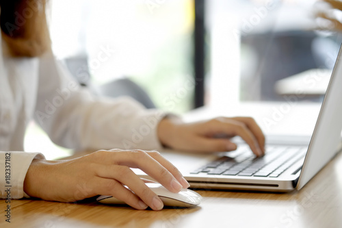 Close up woman working at home office hand on keyboard laptop. © bongkarn