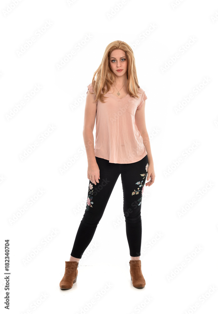 full length portrait of a girl wearing pink shirt and black floral pants. standing pose, isolated on white background. full length portrait of a girl wearing pink shirt and black floral pants. standing pose, isolated on white background.