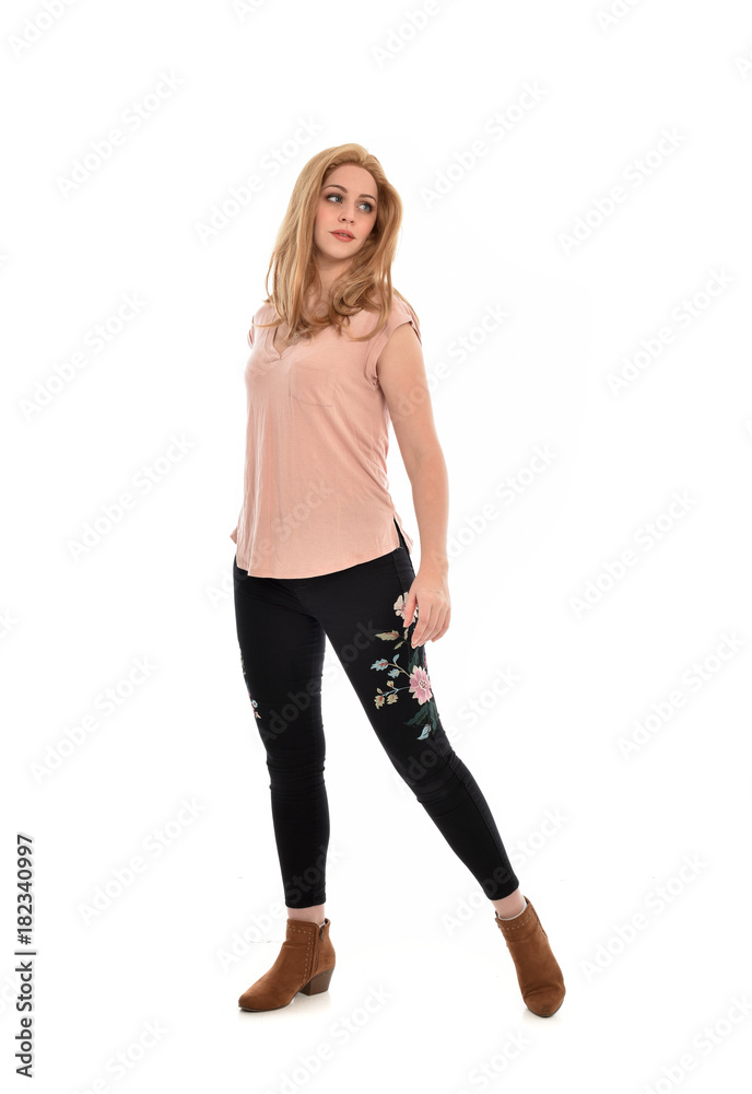 full length portrait of a girl wearing pink shirt and black floral pants. standing pose, isolated on white background. full length portrait of a girl wearing pink shirt and black floral pants. standing pose, isolated on white background.