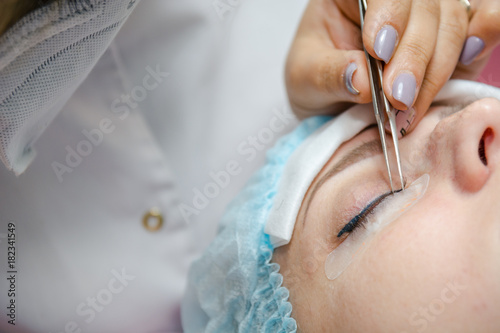 Eyelash extension in beauty shop. Artificial eyelashes.