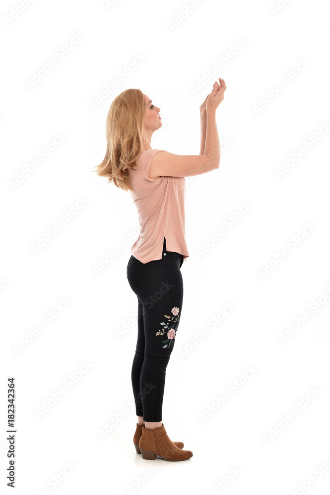 full length portrait of a girl wearing pink shirt and black floral pants. standing pose, isolated on white background. full length portrait of a girl wearing pink shirt and black floral pants. standing pose, isolated on white background.