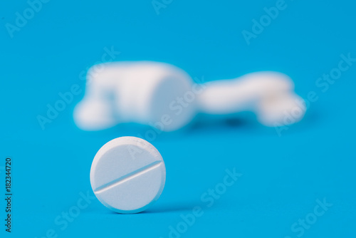 white medical drug on blue background