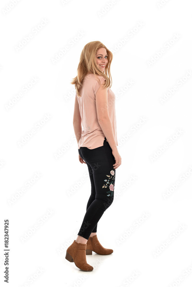 full length portrait of a girl wearing pink shirt and black floral pants. standing pose, isolated on white background. full length portrait of a girl wearing pink shirt and black floral pants. standing pose, isolated on white background.