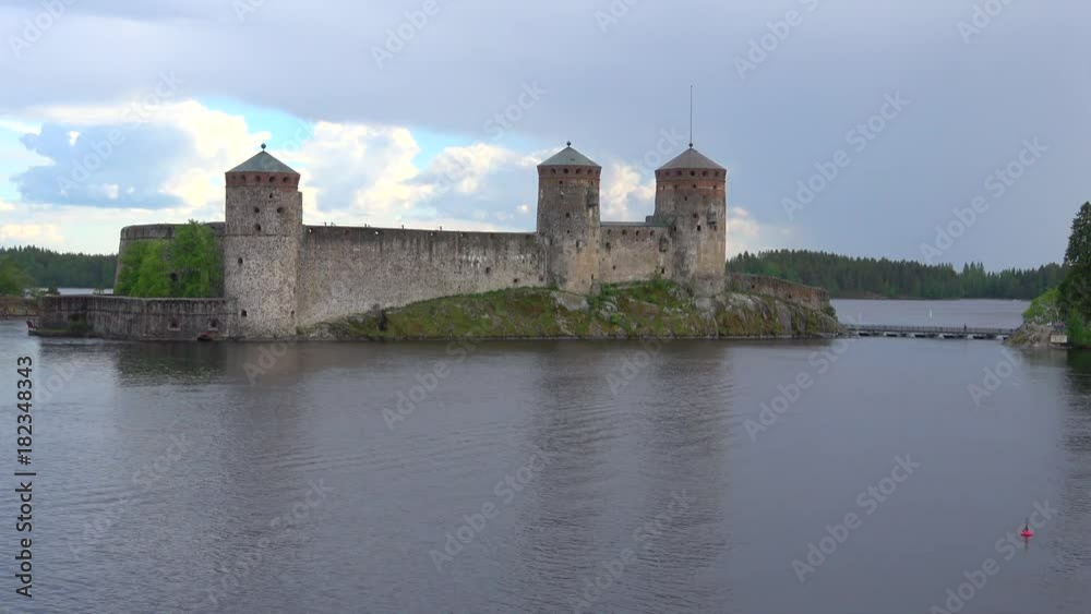 Olavinlinna castle in the strait Kyronsalmi, cloud july evening. Savonlinna, Finland Olavinlinna castle in the strait Kyronsalmi, cloud july evening. Savonlinna, Finland