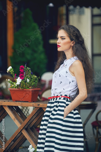 portrait of young beautiful girl . model posing on the street.Urban lifestyle. The concept of women's fashion.